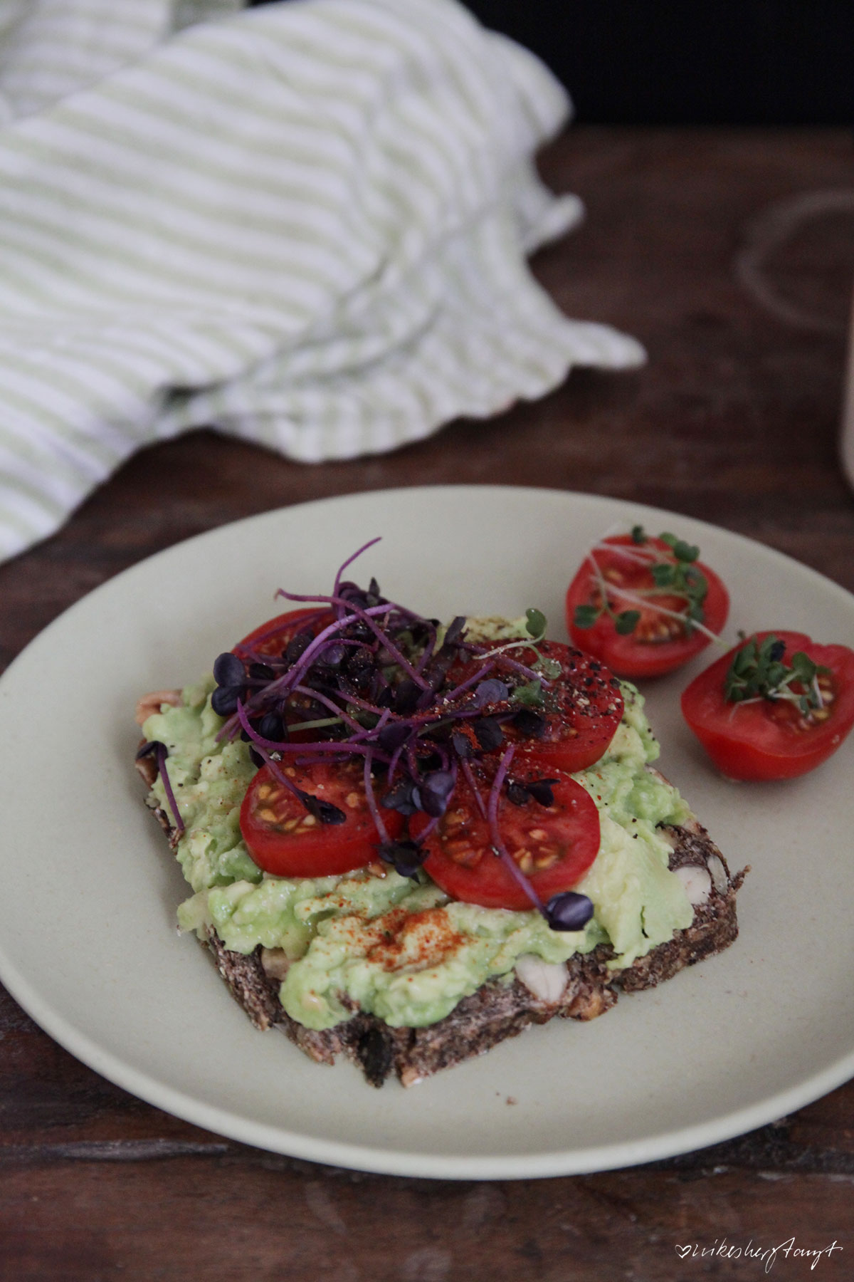 life changing bread with avocado, tomatoes & sprouts